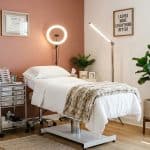 Organized lash suite with treatment bed and ring light